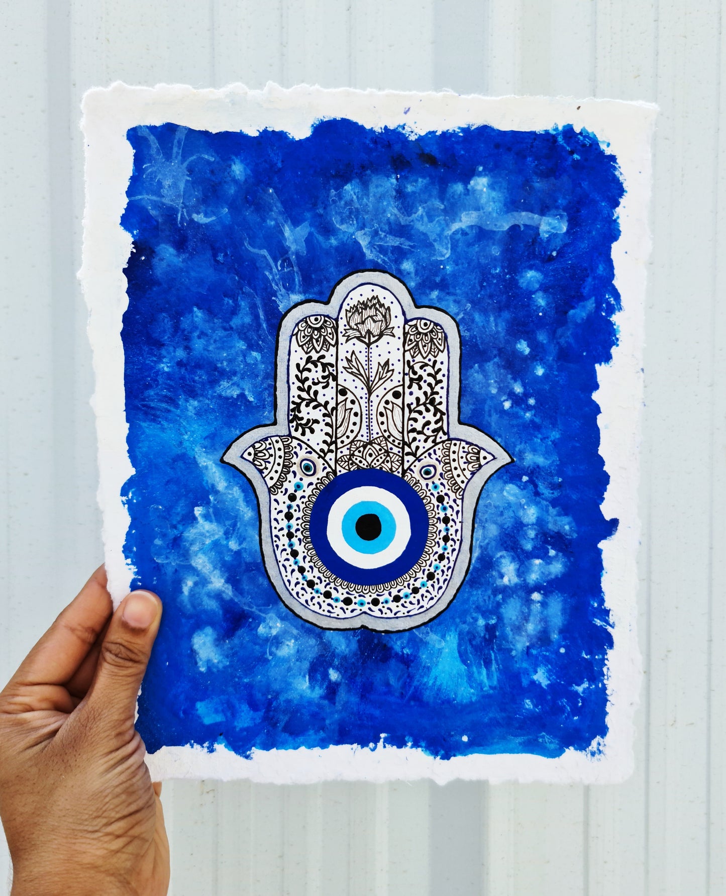 Deatiled Hamsa hand on blue haze background